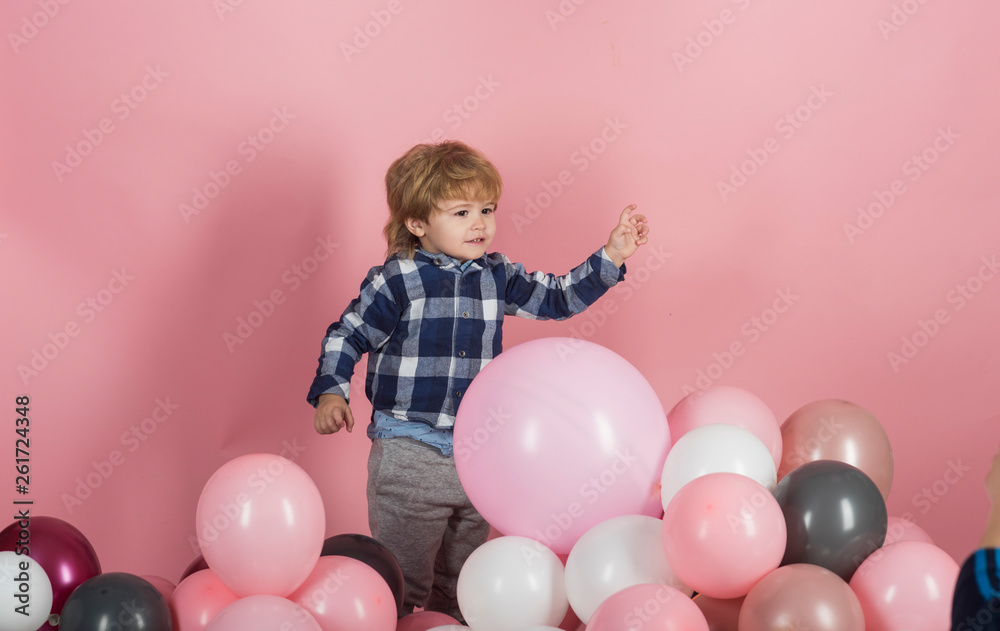 Child plays balloons. Caucasian baby boy plays with baloons at home. Adorable little boy with pink baloon on pink background Child plays balloons. Caucasian baby boy plays with baloons at home. Adorable little boy with pink baloon on pink background