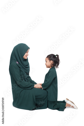 Malay mother and daughter in traditional dress posing