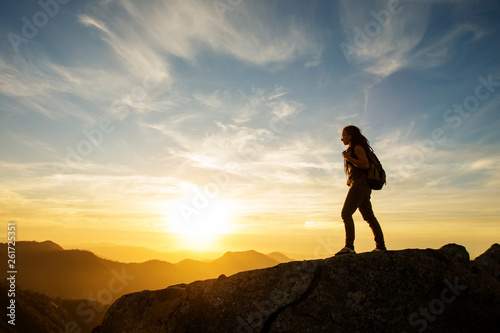 Hiker meets the sunset on the Moro rock in Sequoia national park, California, USA.