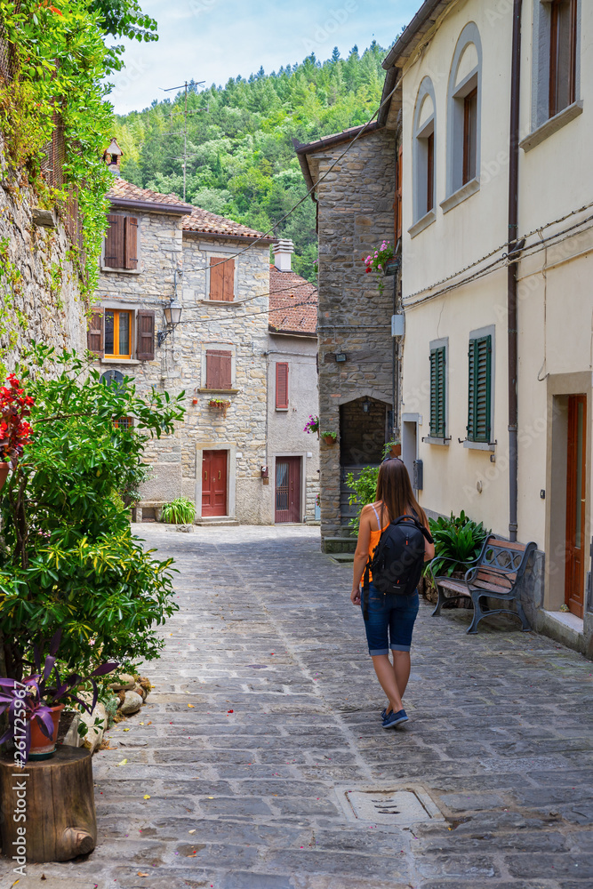 Tourist on a narrow old street in Italy