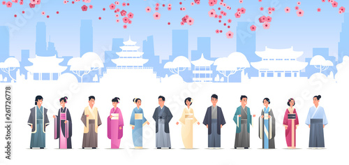 asian people grroup in traditional clothes men women wearing ancient costumes standing together chinese or japanese characters over pagoda buildings landscape background full length horizontal