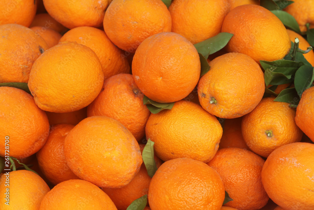 Big pile of ripe oranges with leaves Big pile of ripe oranges with leaves