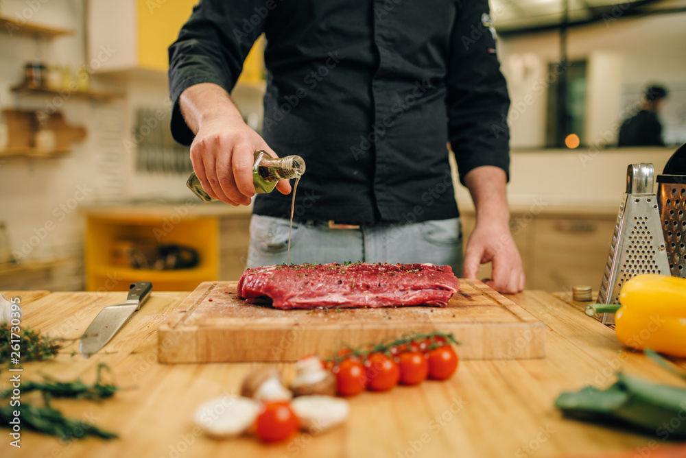 Male person hands seasoning piece of raw meat