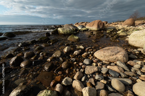 Veczemju Klintis - Boulder beach in Baltic country Latvia in April 2019 - Cloudy sky with dull clouds and a bit of sun