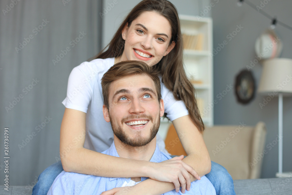 Beautiful woman with boyfriend spending quality time together on sofa at home in the living room. Beautiful woman with boyfriend spending quality time together on sofa at home in the living room.