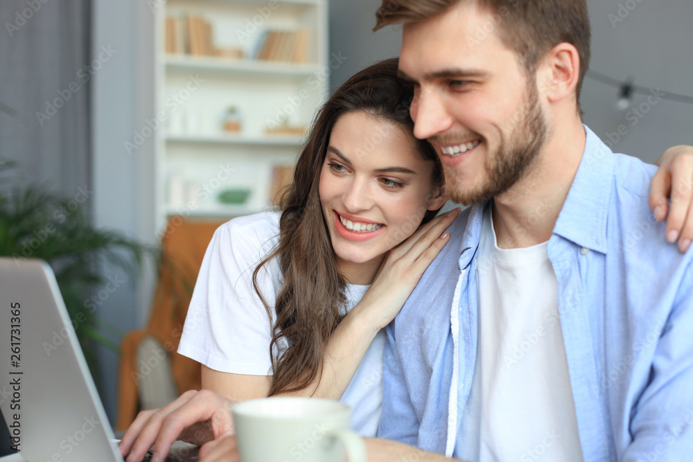 Couple pointing while working together on laptop. Couple pointing while working together on laptop.