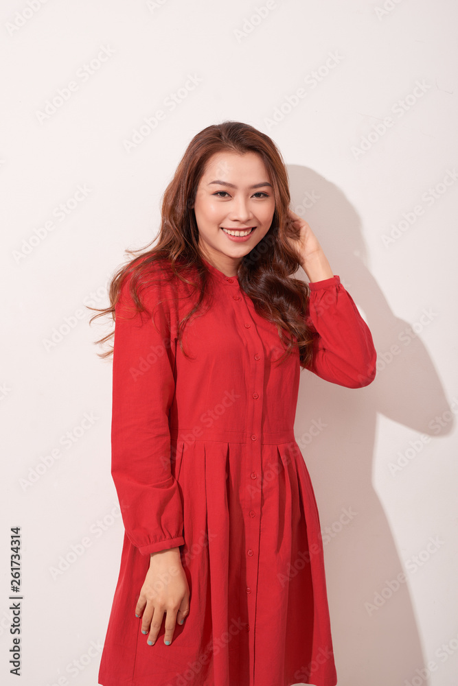 Sexy asian female model posing in red dress. Sexy asian female model posing in red dress.