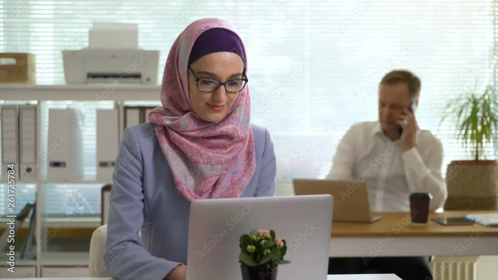 Portrait of professional young muslim business woman wearing traditional headscarf working in the office with a вicycle background Portrait of professional young muslim business woman wearing traditional headscarf working in the office with a вicycle background