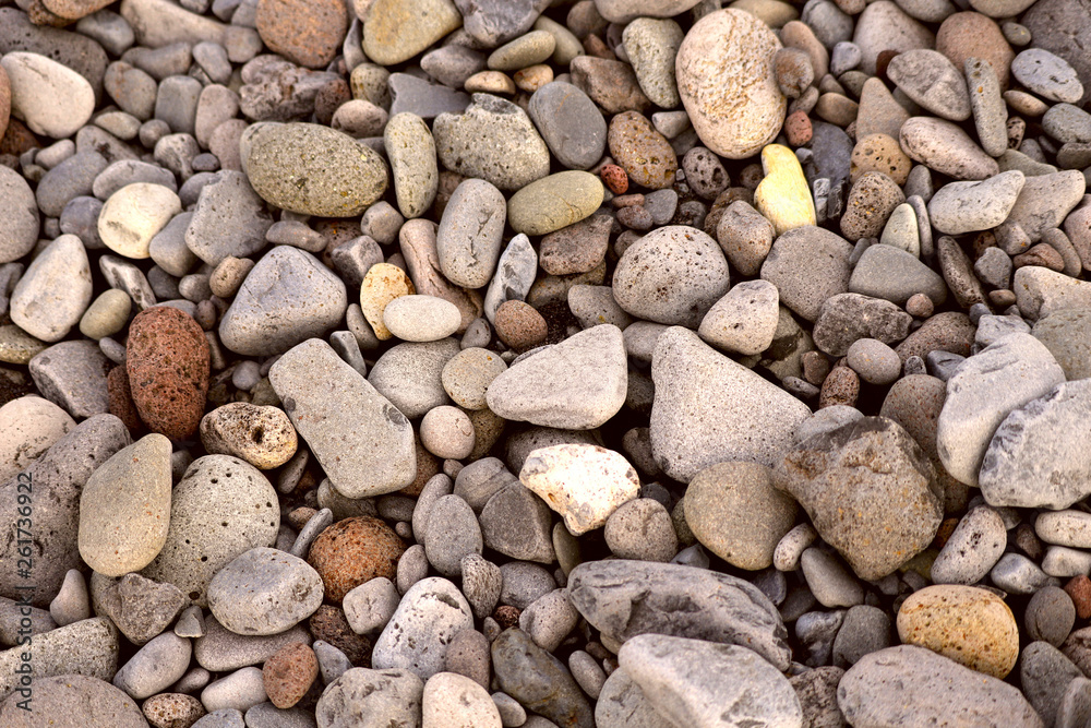 Top view of the pebbles of different size and shape of gray and brown. The concept of nature. Cropped shot, close-up, horizontal. Top view of the pebbles of different size and shape of gray and brown. The concept of nature. Cropped shot, close-up, horizontal.