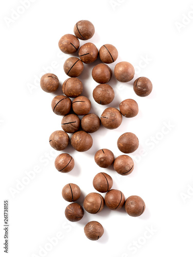 Heap of macadamia nuts on white background with clipping path.. Set of macadamia nuts isolated on white, top view or flat lay. Vertical