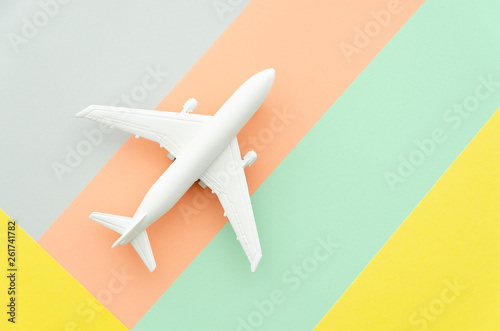 Flat lay design travel concept with plane on blue, blue and peach background with copy space. Runway, fly choose your direction
