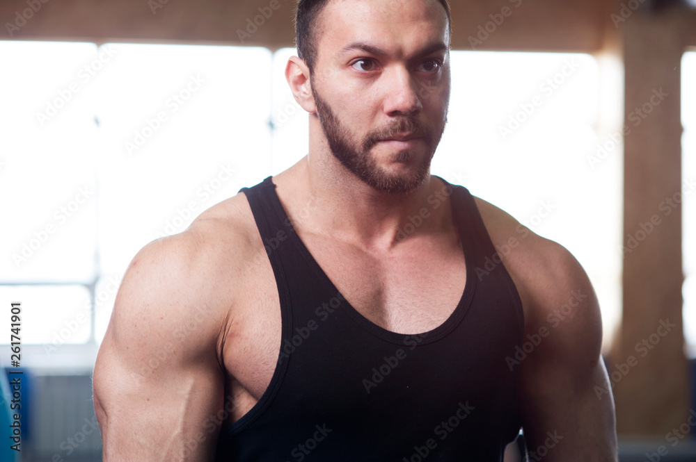 Obraz premium Portrait of Young Strong Man Training in Gym