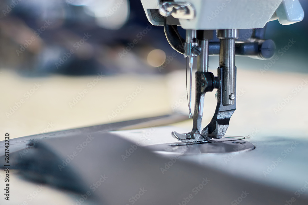Fototapeta premium Industrial sewing machine with bokeh background
