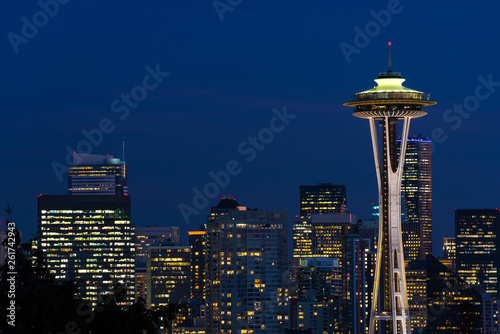 Night view of the Seattle skyline with the Space Needle and other iconic buildings in the background.