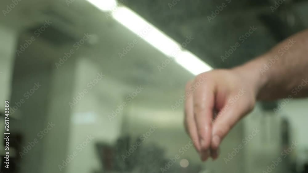 The male hand is heavily salting something. Cook with spices The male hand is heavily salting something. Cook with spices
