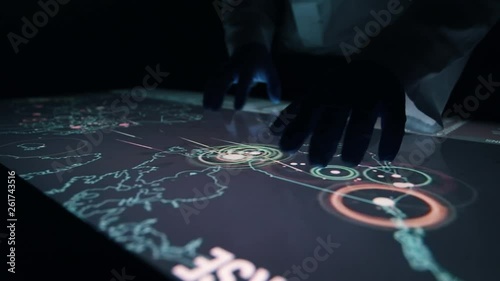 Man indicators on sensor touch screen sensory interactive table in the dark. 