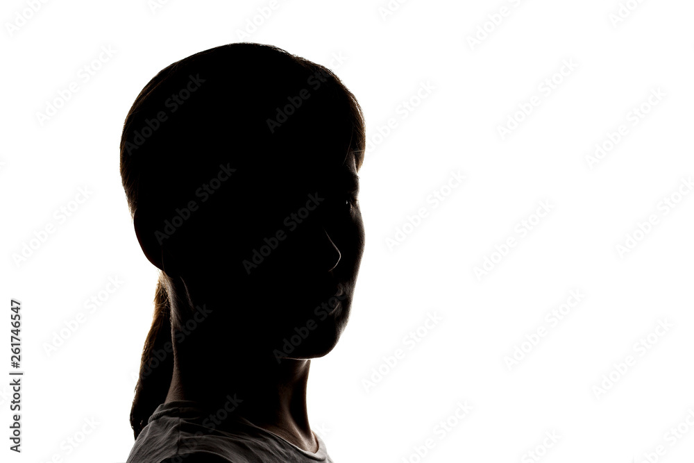 Dark silhouette of a young girl on a white background, the concept of anonymity