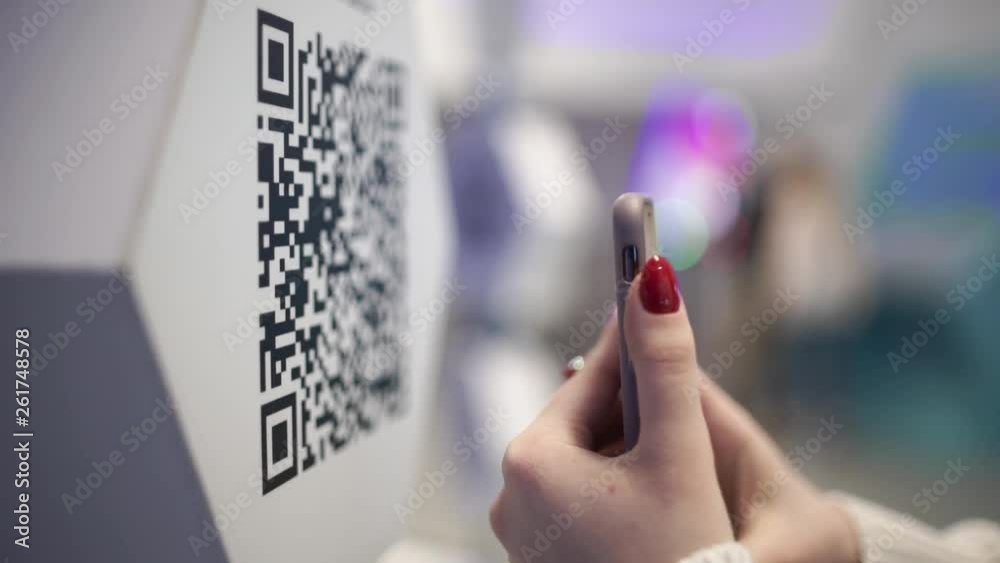 Scanning QR code with smart phone. The man reads the bar code using the application on the smartphone.