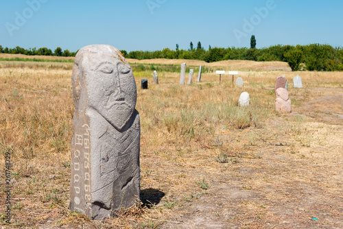 Tokmok, Kyrgyzstan - Aug 08 2018: Kurgan stelae at Ruins of Balasagun in Tokmok, Kyrgyzstan. Balasagun is part of the World Heritage Site-Silk Roads: the Routes Network of Chang'an-Tianshan Corridor. photo