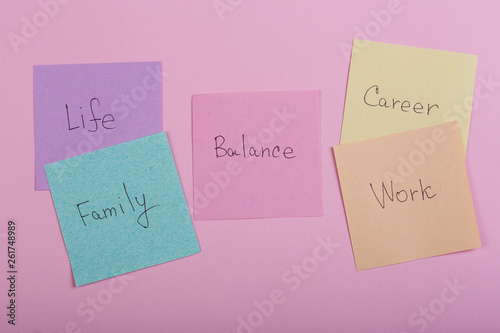 Choosing family or career concept - colorful sticky notes with words balance, work, career, family, life