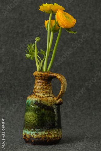 Ranunculus flowers with green leaf in flower vase