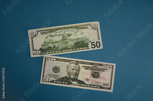 Pack of fifty dollars banknotes isolated on blue background