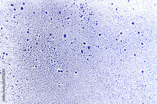 Blue drops and blobs on a white surface