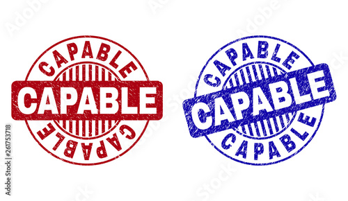 Grunge CAPABLE round stamp seals isolated on a white background. Round seals with grunge texture in red and blue colors. Vector rubber overlay of CAPABLE title inside circle form with stripes.