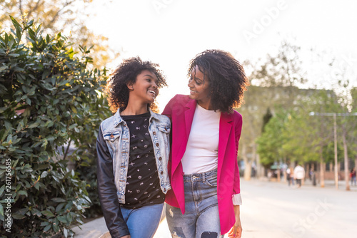 Mother and Daughter Walking Together Outdoors.