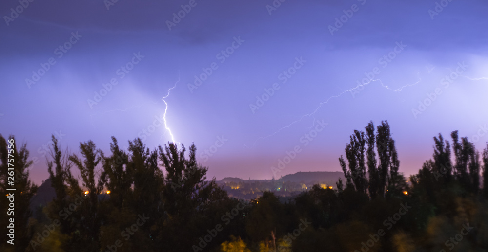 Night lightning storm over city in blue dramatic lighting