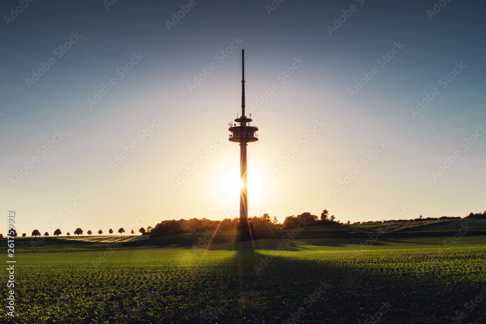 Obraz premium Antenna radio tower building at colorful evening sunset tones with shadows in the nature landscape view. Old town of Braunschweig, Germany