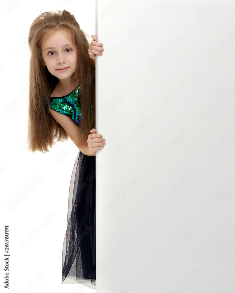 A little girl is looking from behind an empty banner. A little girl is looking from behind an empty banner.