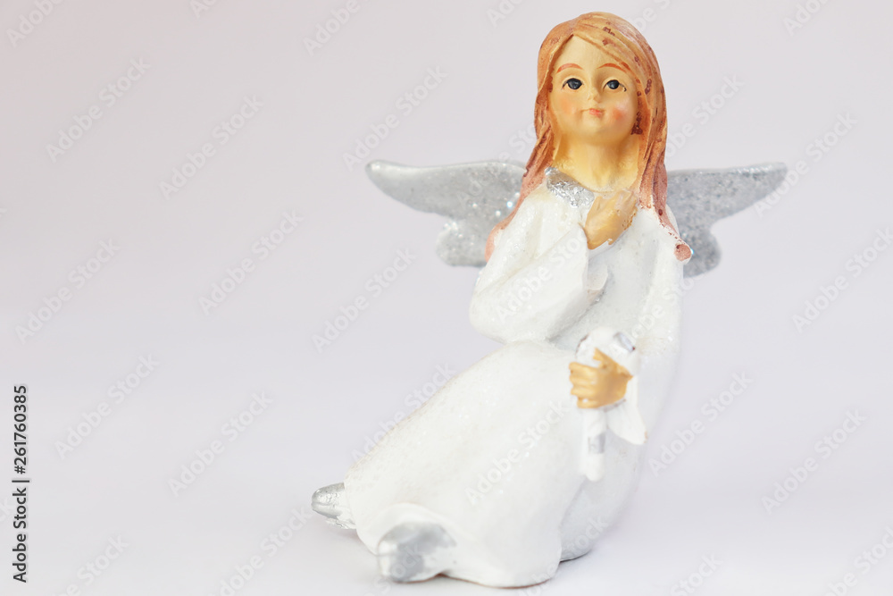 White angel with a bunch of willow branches with artificial flowers. White angel with a bunch of willow branches with artificial flowers.