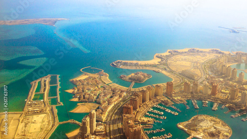 Aerial view of the Pearl-Qatar, the luxurious and modern artificial island in Persian Gulf, Doha, Qatar, Middle East. Venice at Qanat Quartier, Marsa Malaz Kempinski hotel and towers of Porto Arabia. photo