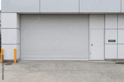 A closeup shot of automatic metal roller door used in factory, storage, garage, and industrial warehouse. The corrugated and foldable metal sheet offer space saving and provide urban and rustic feel