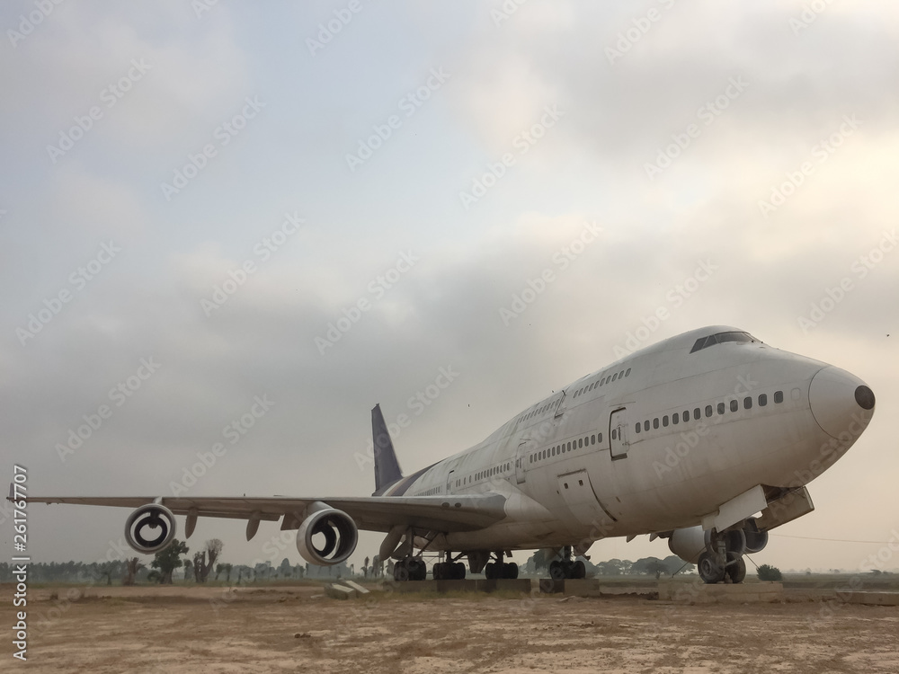 Old abandoned plane parking on the dry ground airfield with sky and clouds Old abandoned plane parking on the dry ground airfield with sky and clouds