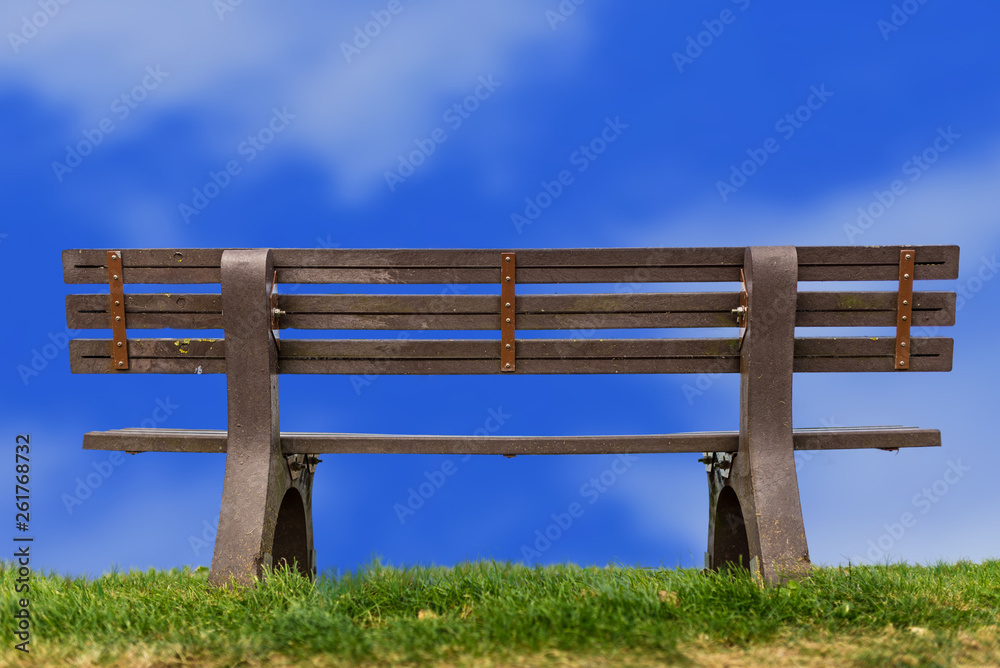 Lonely and peaceful bench at the top of a hill under blue sky. Lonely and peaceful bench at the top of a hill under blue sky.