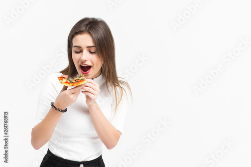 People and fast food concept  Girl eatind slice of pizza Margarita 