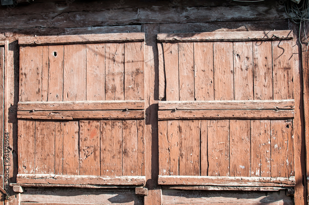Old weathered grunge closed wooden boards window shutters of vintage country house Old weathered grunge closed wooden boards window shutters of vintage country house
