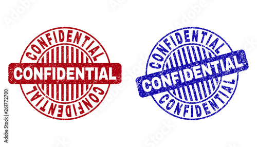 Grunge CONFIDENTIAL round stamp seals isolated on a white background. Round seals with grunge texture in red and blue colors.