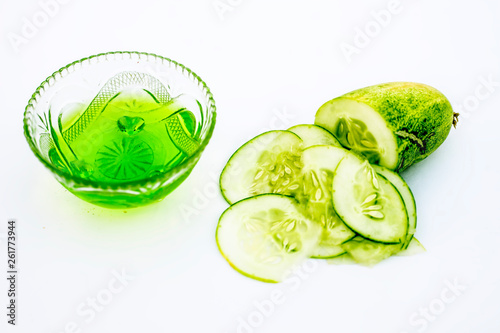 Raw cucumber along with some aloe vera gel well mixed in a glass bowl isolated on white entire ingredients.Used to rejuvenate your skin and for instant glow.