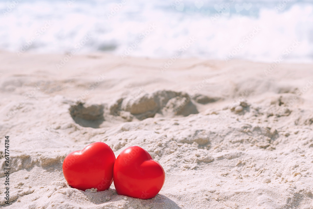Red hearts on tropical beach in sunny day with free copy space for text. Love and valentine background concept. Red hearts on tropical beach in sunny day with free copy space for text. Love and valentine background concept.