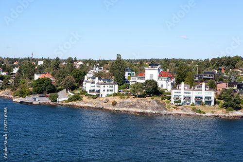 Fototapeta Naklejka Na Ścianę i Meble -  Many different building and houses are on coastline of Stockholm archipelago in Sweden. Joint valley landscape. Scandinavia