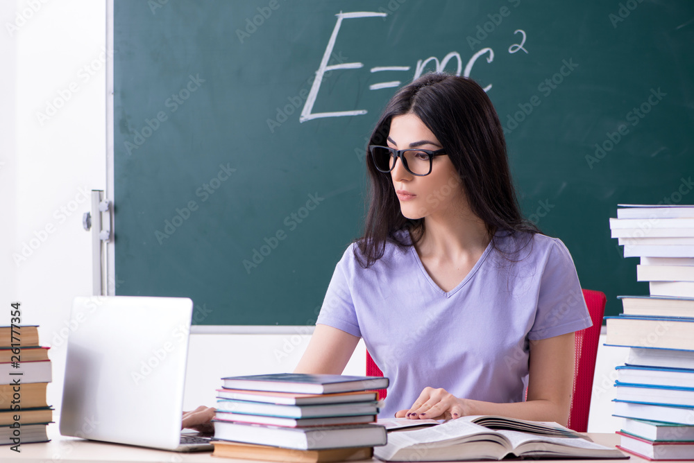 Young female teacher student in front of green board Young female teacher student in front of green board