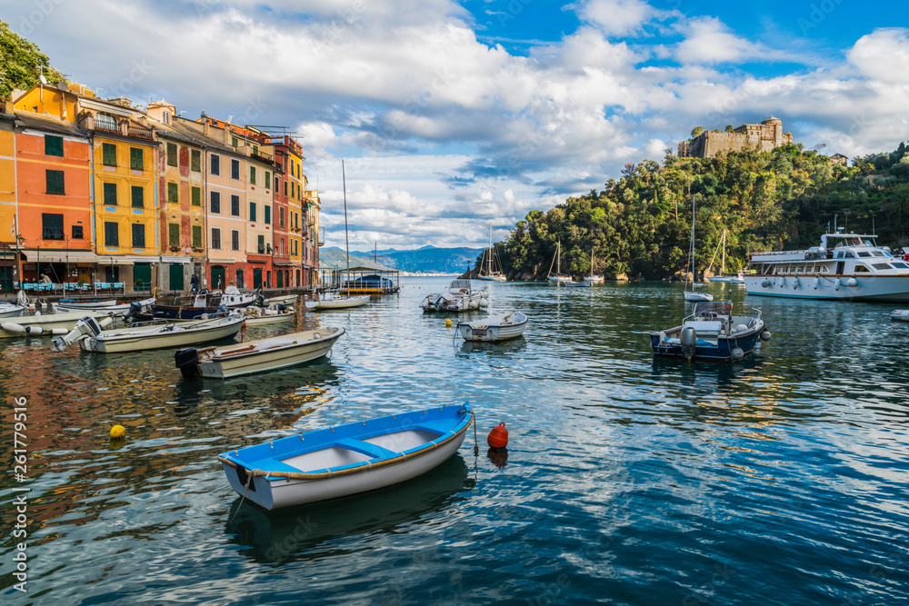 Boats and yachts on the sea in the spectacular harbour of coastal town Portofino in the Liguria region, Italy