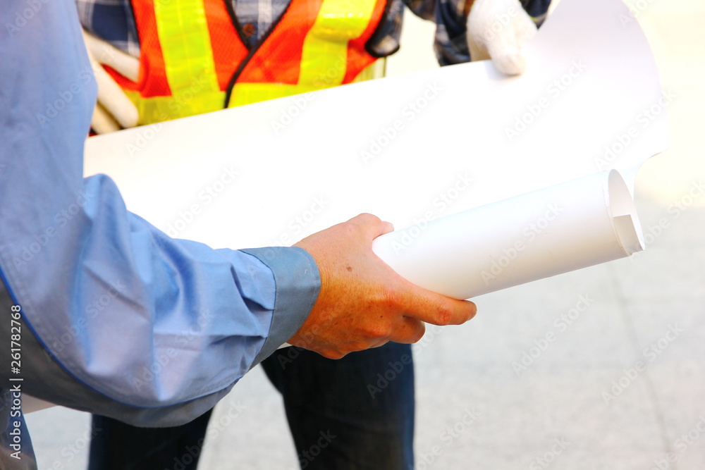 architect holding blank blueprints architect holding blank blueprints