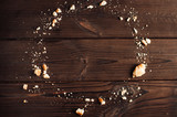 Crumbs from chocolate cookies on a wooden table background. Copyspace