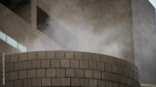 Steam rises from boiler on cold rainy day
