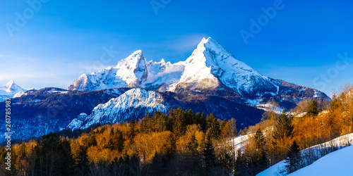 Beautiful winter wonderland mountain scenery in the Alps with pilgrimage church of Maria Gern and famous Watzmann summit in the background, Berchtesgadener, Bavaria, Germany