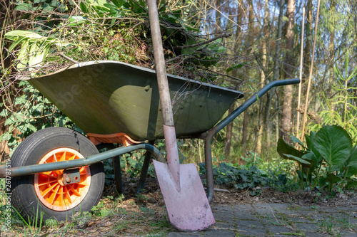 Wallpaper Mural Wheelbarrow filled with leaves and branches with a fanned spade after gardening in spring Torontodigital.ca